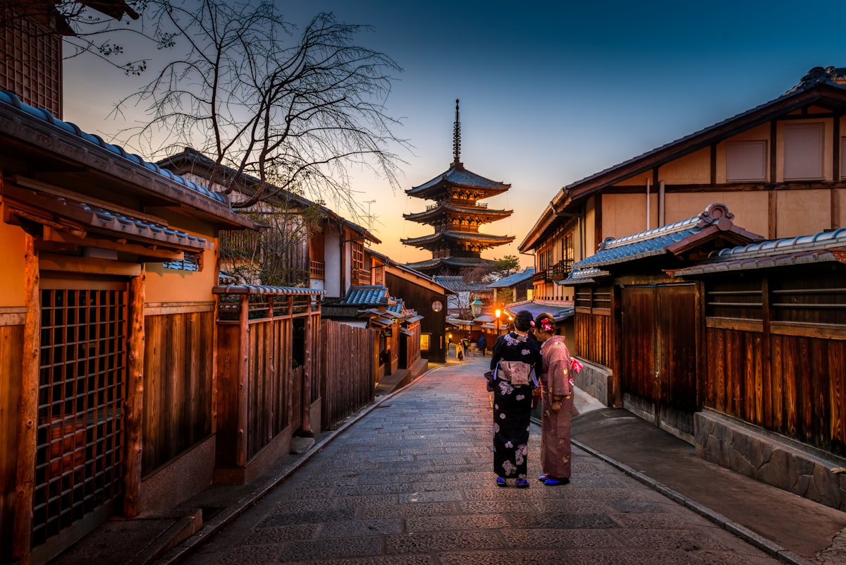 Traditional Kyoto street at dusk with wooden machiya and Yasaka Pagoda, evoking the hidden-studio world of tebori