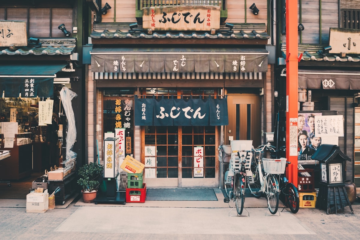 Traditional Japanese wooden storefront with noren curtain and lattice doors