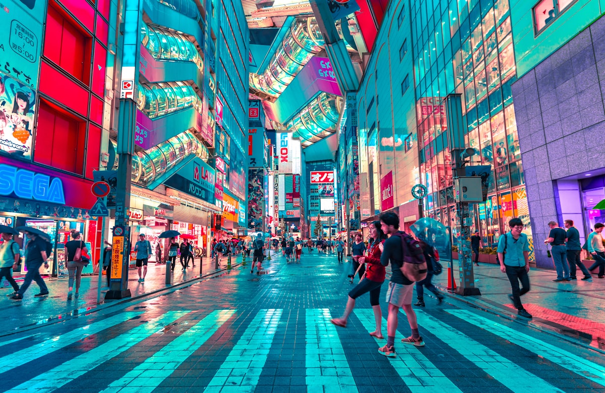 Neon-lit Tokyo street at night with wet pavement and cinematic urban colour